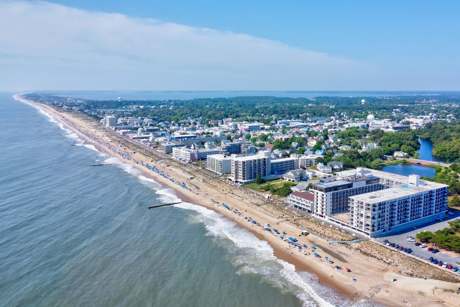 Rehoboth Beach boardwalk with shops, restaurants, and ocean views on a sunny day